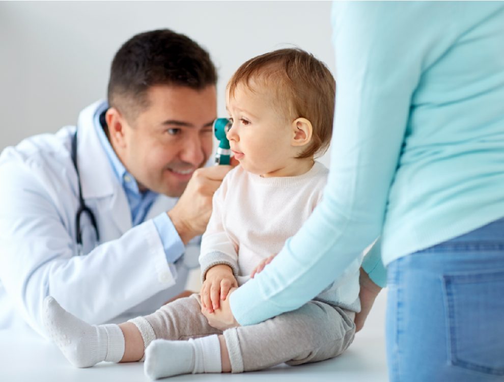 doctor-with-otoscope-checking-baby-ear-at-clinic-pmnnrxg